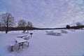 Willow river state park snow covered picnic tables on the frozen beach in Winter Royalty Free Stock Photo