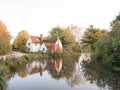 willy lotts cottage at flatford mill in suffolk in autumn reflections in lake Royalty Free Stock Photo