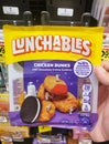 Wilmington, Delaware, U.S.A - February 22, 2024 - Holding a Lunchables pack, which includes chicken dunks with chocolate creme Royalty Free Stock Photo