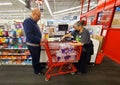 Wilmington, Delaware, U.S.A - March 28, 2023 - A customer buying bottled water and a cashier ringing up the purchase at Staples