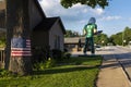 A stretch of the historic route 66 in the city of Wilmington, wih an American Flag and the Gemini Giant statue, in the State of Il