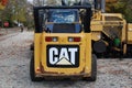 The back end of a CAT Caterpillar brand construction vehicle, parked on the workers` day off.