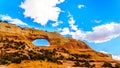 Wilson Arch under blue sky, a sandstone arch along US Highway 191, south of the town of Moab Royalty Free Stock Photo