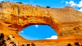 Wilson Arch under blue sky, a sandstone arch along US Highway 191, south of the town of Moab Royalty Free Stock Photo