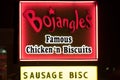 A Bojangles` sign is illuminated at night