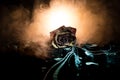 A wilting rose signifies lost love, divorce, or a bad relationship, dead rose on dark background with smoke Royalty Free Stock Photo