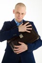 Wily caucasian man in suit holding briefcase in hands on white background.