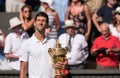 Novac Djokovic, Serbian player, wins Wimbledon for the fourth time. In the photo he holds his trophy on centre court.
