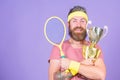 Win every tennis match i take part in. Tennis player win championship. Athlete hold tennis racket and golden goblet. Man Royalty Free Stock Photo