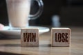 Win and Lose, on wooden cubes and cacao cup. Business success and failure concept Royalty Free Stock Photo