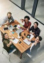 We win when we work as one. High angle portrait of a group of colleagues giving a thumbs up during a meeting in a modern Royalty Free Stock Photo