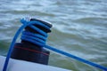 Winch on boat with blue rope.