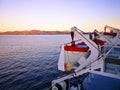 Winch and lifeboat of a blue and white ferry