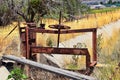 Winch of pair of rusty antique irrigation ditch gates against sky with tall grass in Heber City, Utah along the back side of the W Royalty Free Stock Photo