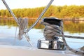 A winch on a sailing yacht for pulling up files and sheets against the background of the summer sea. Outfit of a sailing yacht. Fa