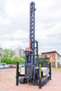 Construction platform on rubber crawler tracks with a winch, metal boom and vertical lifting mechanism