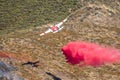 Winchester, CA USA - June 14, 2020: Cal Fire aircraft drops fire retardant on a dry hilltop wildfire near Winchester, California