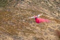 Winchester, CA USA - June 14, 2020: Cal Fire aircraft drops fire retardant on a dry hilltop wildfire near Winchester, California