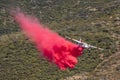 Winchester, CA USA - June 14, 2020: Cal Fire aircraft drops fire retardant on a dry hilltop wildfire near Winchester, California