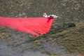 Winchester, CA USA - June 14, 2020: Cal Fire aircraft drops fire retardant on a dry hilltop wildfire near Winchester, California