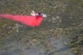 Winchester, CA USA - June 14, 2020: Cal Fire aircraft drops fire retardant on a dry hilltop wildfire near Winchester, California