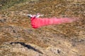 Winchester, CA USA - June 14, 2020: Cal Fire aircraft drops fire retardant on a dry hilltop wildfire near Winchester, California