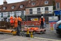 11/06/2019 Winchester, Hampshire, UK construction worker or builder working in high visibility clothing while digging up pipes in