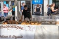 A man selling pastry on a market stall