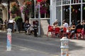 09/02/2019 Winchester, Hampshire, UK People eating outside at the front of a cafe and pub, a typical british summer scene