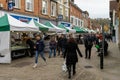 11/06/2019 Winchester, Hampshire, UK Shopper walking through a high street next to market stalls