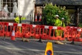 11/06/2019 Winchester, Hampshire, UK Three Builders in high visibility clothing behind a barrier in the road standing around Royalty Free Stock Photo