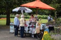 Two elderly women buying an Ice cream from a traditional ice cream sellers bicycle in an