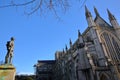 WINCHESTER, UK - FEBRUARY 4, 2017: Exterior view of the Cathedral with the statue of First World War Soldier on the left hand side