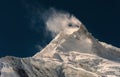 Wind blowing snow from mountain peak