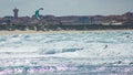 Training kitesurfing in the bustling waters of Baleal beach, Portugal