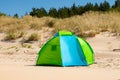 Wind breaker tent on a sandy beach by the sea. Nobody. Colorful tent protection from wind and sunburn