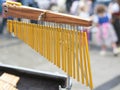 Wind chime pipes with croud in background Royalty Free Stock Photo