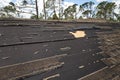 Wind damaged house roof with missing asphalt shingles after hurricane Ian in Florida. Repair of home rooftop concept Royalty Free Stock Photo