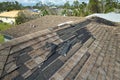 Wind damaged house roof with missing asphalt shingles after hurricane Ian in Florida. Repair of home rooftop concept Royalty Free Stock Photo