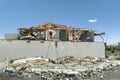 Wind destroyed house roof and walls with missing asphalt shingles after hurricane Ian in Florida. Demolition of building