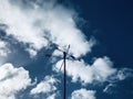 Wind direction indicator, with the cumulus sky background. Royalty Free Stock Photo