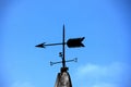 Wind direction indicator on the roof against the blue sky Royalty Free Stock Photo