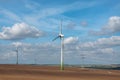 Wind electric generators on field. Royalty Free Stock Photo
