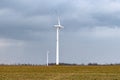 Wind energy concept. Turbines in rural area to supply countryside with electricity Royalty Free Stock Photo