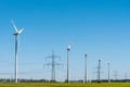Wind energy plants and an overhead power line Royalty Free Stock Photo