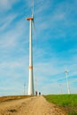 Wind energy.Windmills and People near on the road on a blue sky background.Wind generators.Natural energy.Alternative Royalty Free Stock Photo