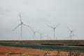 Wind energy. Windmills set and lambs in a field in foggy cloudy weather. Natural renewable clean eco energy. Alternative Royalty Free Stock Photo