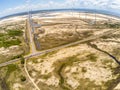 Wind farm with dunnes, road and vegetation