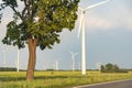 Wind farm with many wind turbines beside a country road in  Germany Royalty Free Stock Photo