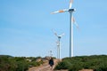 Wind farm in the mountains of Madeira Island. A lone figure of a pedestrian on a field road. Copy space. Royalty Free Stock Photo